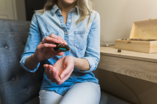 Young Woman Applying Essential Oils To Her Wrist