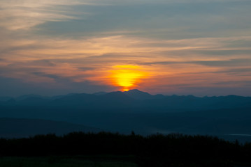 Sunrise among forests and mountains