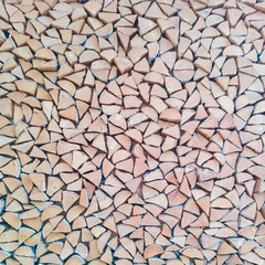 Textured wall made of sawn birch logs folded in a neat pattern