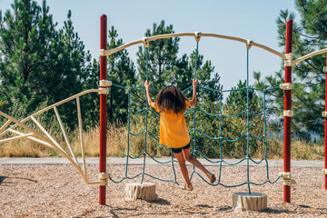 Girl playing in playground alone