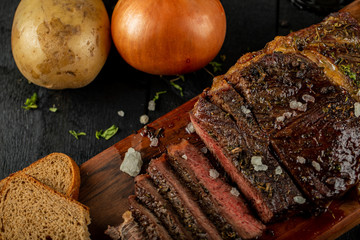 Sliced meat barbecue served with sea salt,bread slices and onion