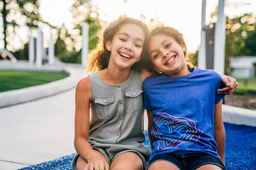 Portrait of smiling sisters outside in park