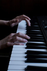 Fototapeta na wymiar hands play the piano. black piano. white and black keys