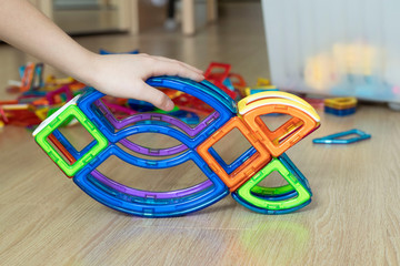 hand of a child assembling a constructor at home
