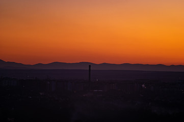 Sunset on the background of the city in spring