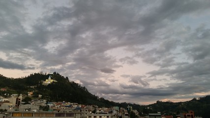 Curious and striking agglomeration or formation of gray clouds at sunset, with mosaic and cobweb patterns. Beneath the small town.