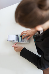 Female business accountant working at her office desk