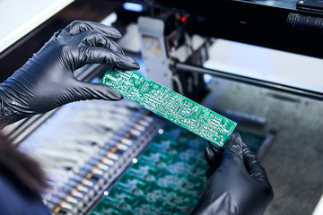 Engineer factory worker electronics works with a chip (board). Microchip Production, Nano computer...