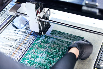 Engineer factory worker electronics works with a chip (board). Microchip Production, Nano computer Technology and manufacturing technological process