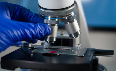 Close-up shot of laboratory microscope with blood sample.