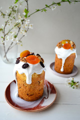Traditional Easter cake with icing and dried fruit on top. Paska or kulich sponge cake.