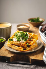 Belgian waffles with cheese and herbs, coffee, tasty breakfast, copy space
