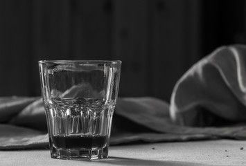 small bitter glass on a table of a wooden chalet