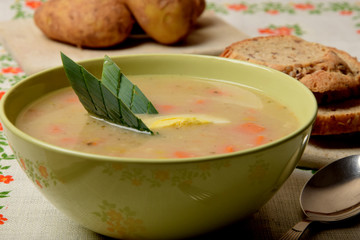 white sour soup with sausage, egg and bread