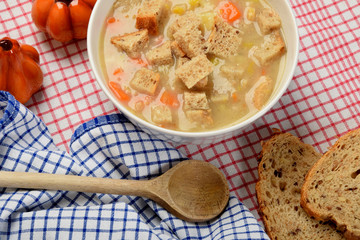 home made potato soup in a bowl with pieces of dry bread