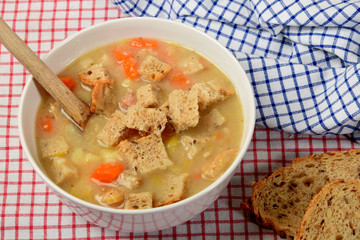 home made potato soup in a bowl with pieces of dry bread