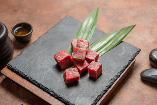 Fresh raw beef brisket slice set on the black marble dish rock. healthy and raw food concept