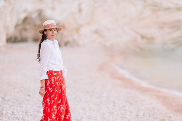 Obraz premium Woman laying on the beach enjoying summer holidays looking at the sea