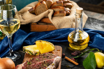 Raw meat with spices and vegetables,pineapple slices, olive oil