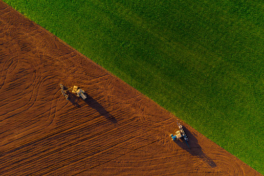 Harvesters working in the field at spring and plowing the field. Sowing work