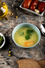 Broth soup with carrot and potatoes in a bowl