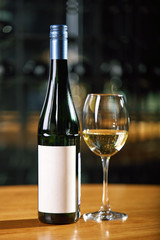 A bottle of wine and glasses on the table, against the background of a wine shakafa. Serving and serving wine. Winemaking concept, copy space.