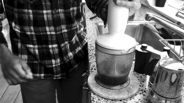 Person making bulletproof coffee at home for breakfast