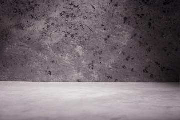 Empty room with concrete wall, grey background.