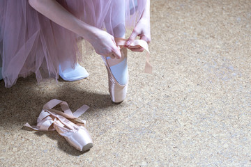 Ballerina tying pointe ballet shoes. Distant training with, social distance or self-isolation, online education concept.
