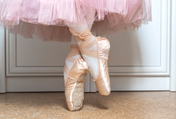 Legs of ballerina in ballet shoes, closeup. Distant training with, social distance or...