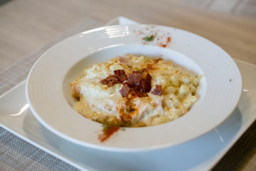 Angle view of macaroni and cheese top with bacon.