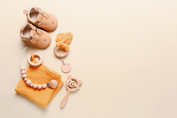 Set of baby shoes, toys and accessories on beige background. Fashion newborn stuff. Flat lay, top...