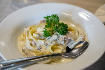Angle view of fettuccine carbonara ham cheese.
