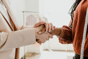 Fashion designer shaking hands with a client