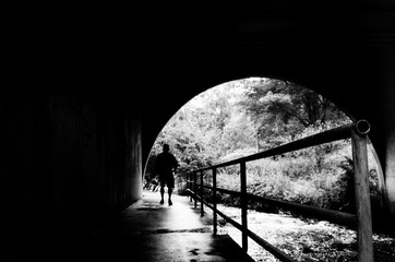 Man walking through underpass