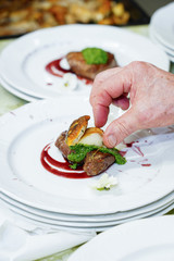 beef fillet with porcini mushrooms, hands of a cook. Steak filet mignon with porcini mushrooms and creamy mushroom sauce with greens. food preparation