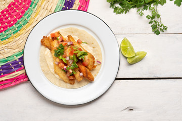 Mexican breaded fish tacos also called ensenada on white background