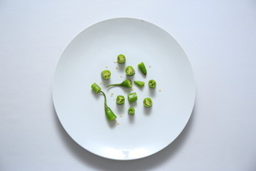 Chopped green chilli isolated on a white bowl