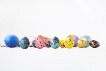 Eggs are painted on a white background. Small and large hand-painted eggs. Multi-faceted photography. Holiday and joy of Bright Easter for the whole family
