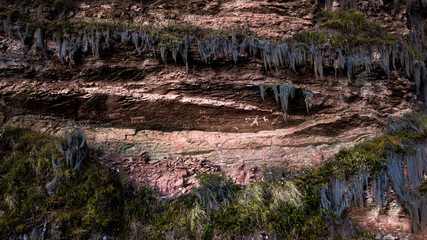 Aerial view on 5000 years old cave paintings presenting a man and animals with plants around it, in Yucay, Sacred Valley of Incas, Cusco, Peru.  