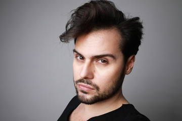 Obraz premium Headshot of serious bearded man looks straight with confident expression. isolated.