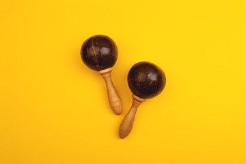 Two mexican maracas isolated on yellow background. Traditional folk musical instruments. Elements of national culture. Flat lay. Latin music.
