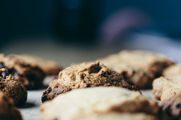 Homemade artisan chocolate cookies in a row on a wooden board