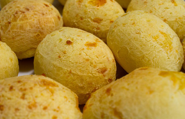 Brazilian cheese bread (pão de queijo), a traditional and popular snack, freshly baked and golden brown, arranged on a rustic table. A delicious symbol of Brazilian cuisine