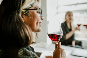 Classy businesswomen enjoying wine