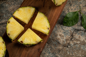 Pineapples sliced on a wooden board
