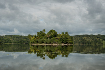 Fototapeta na wymiar Island reflection on a lake in Guatemala during a cloudy day