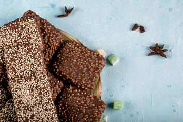 Bitter chocolate bars with anise aroma on blue table