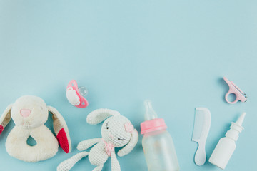 Children's personal care kit. Baby's accessories on blue background, top view.