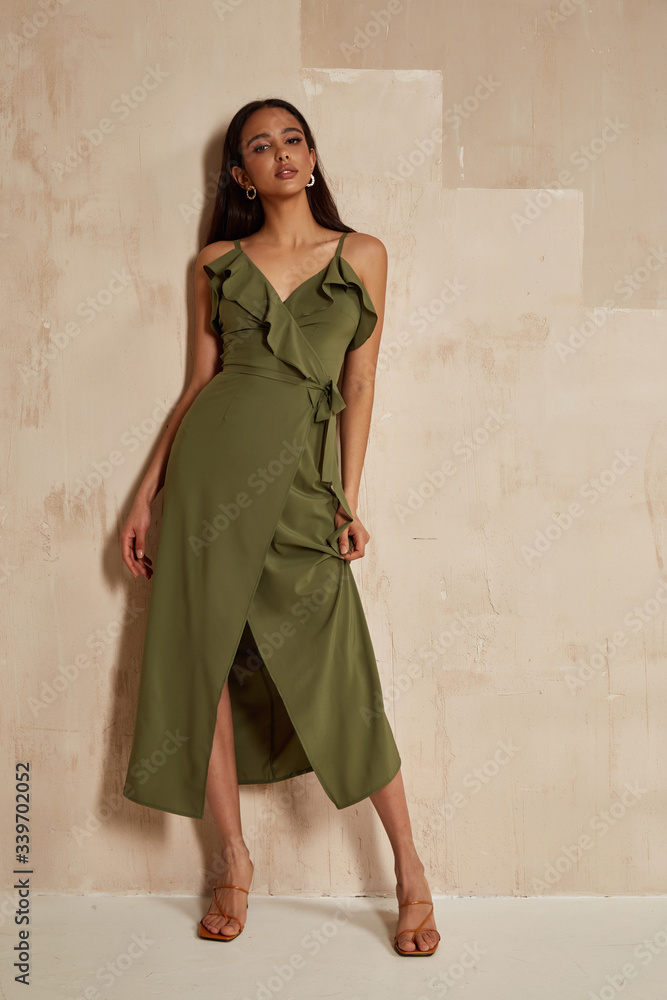 Wall mural fashion model brunette hair wear green silk dress sandals high heels accessory bag clothes for date 